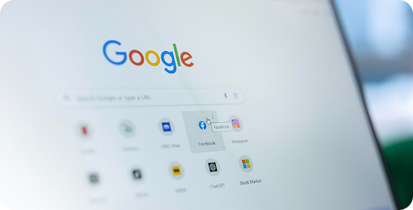 A group meeting around a table with papers and laptops shows a digital overlay of tech icons such as gears and a globe, symbolizing teamwork and innovation.